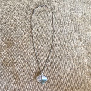 Silver necklace with crystal-style pendant.